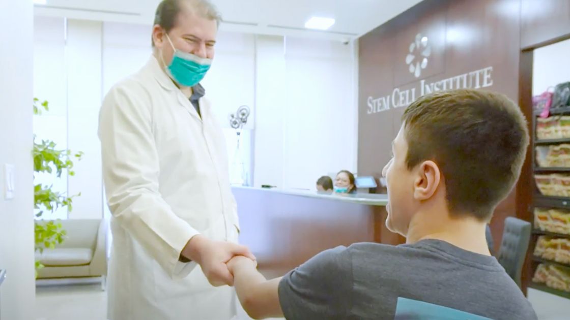 Owen shaking the doctor's hand at Stem Cell Institute Panama