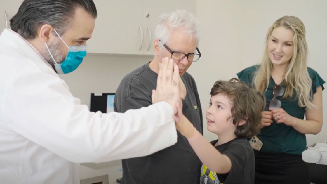 Dylan giving the doctor a high five at Stem Cell Institute